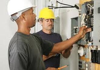 Electricians repairing circuit box